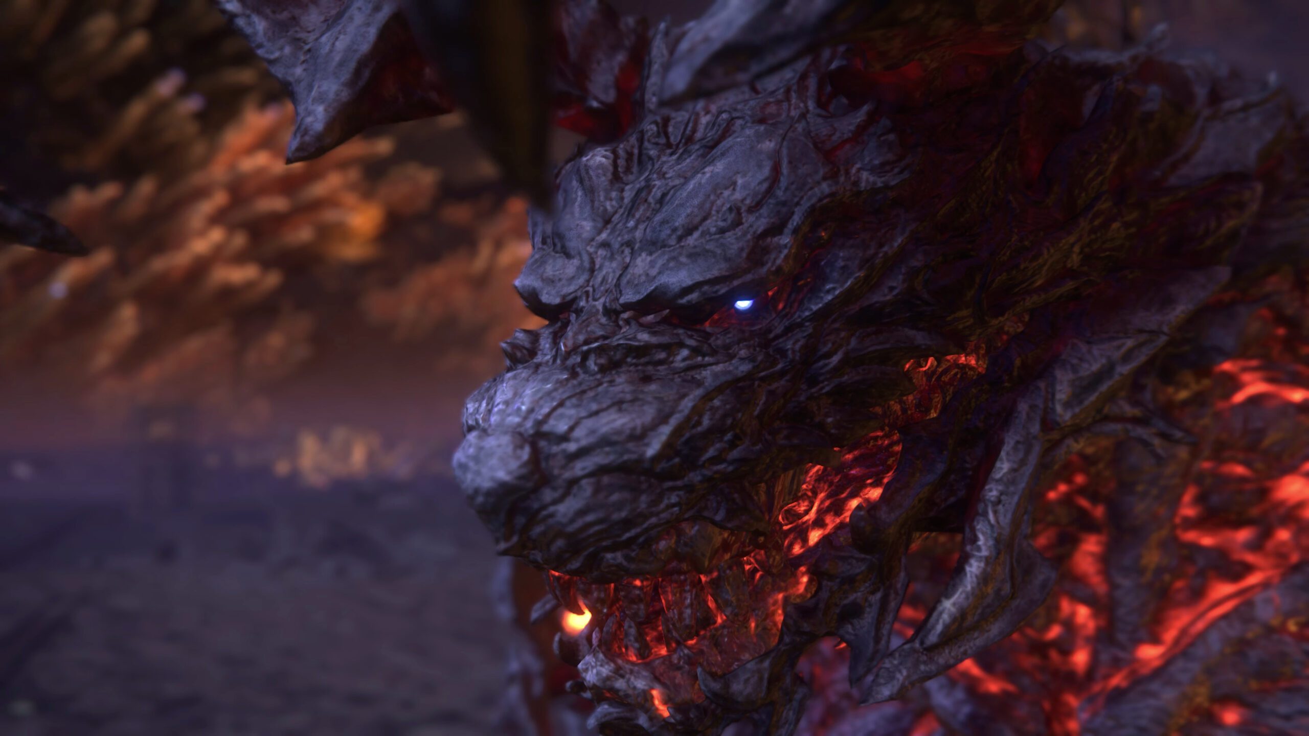 A close up of the Eikon Ifrit’s face. A red glow pulses through his teeth, contrasting with the pale blue in his eyes. 